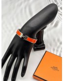 (LIKE NEW) HERMES CLIC H BRACELET IN PALLADIUM PLATED WITH ORANGE ENAMEL