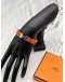 (LIKE NEW) HERMES CLIC H BRACELET IN PALLADIUM PLATED WITH ORANGE ENAMEL