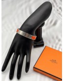 (LIKE NEW) HERMES CLIC H BRACELET IN PALLADIUM PLATED WITH ORANGE ENAMEL