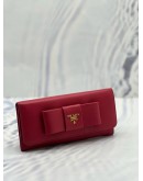 PRADA BOW CONTINENTAL WALLET IN PINK SAFFIANO LEATHER