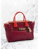 (UNUSED) COACH SWAGGER CARRYALL BURGUNDY RED HANDLE CROSSBODY / SHOULDER HANDBAG WITH LONG STRAP