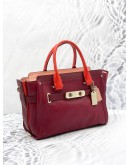 (UNUSED) COACH SWAGGER CARRYALL BURGUNDY RED HANDLE CROSSBODY / SHOULDER HANDBAG WITH LONG STRAP